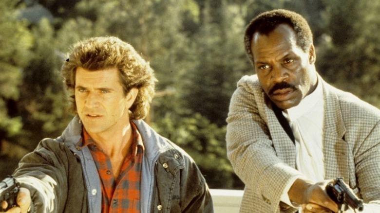 Riggs and Murtaugh  holding guns