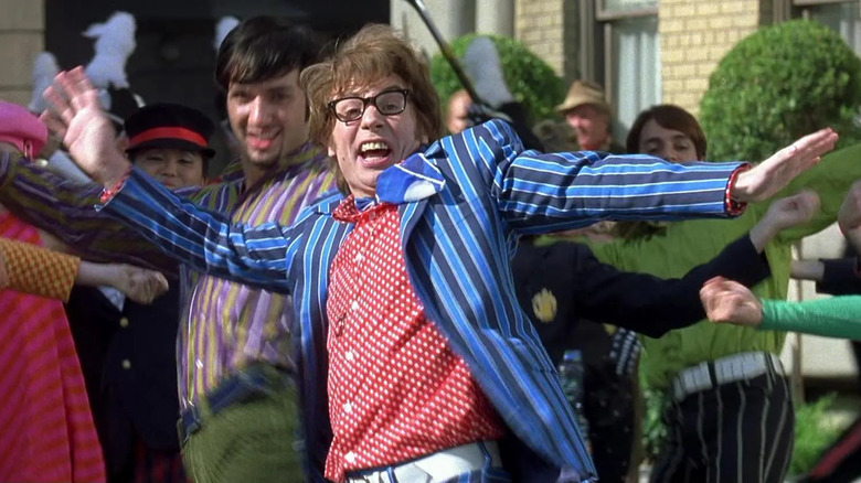 Austin Powers leads a coordinated dance number on a public street.