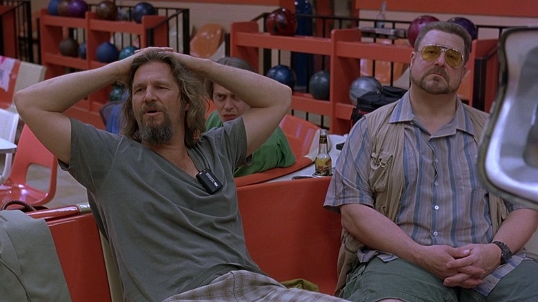 Lebowski and Donney sit in the bowling alley, waiting for their turn.