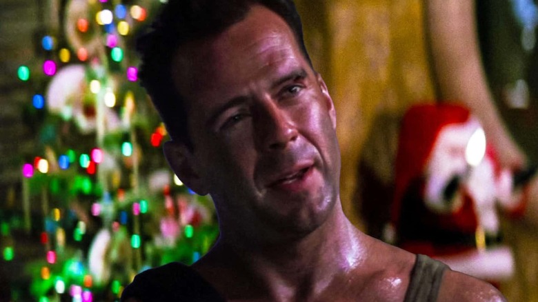 John McClane talks with a Christmas tree behind him in "Die Hard" (1988)