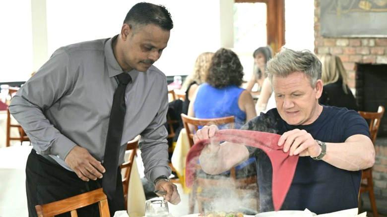 Chef Gordon Ramsay holding a napkin over food at Diwan in Kitchen Nightmares