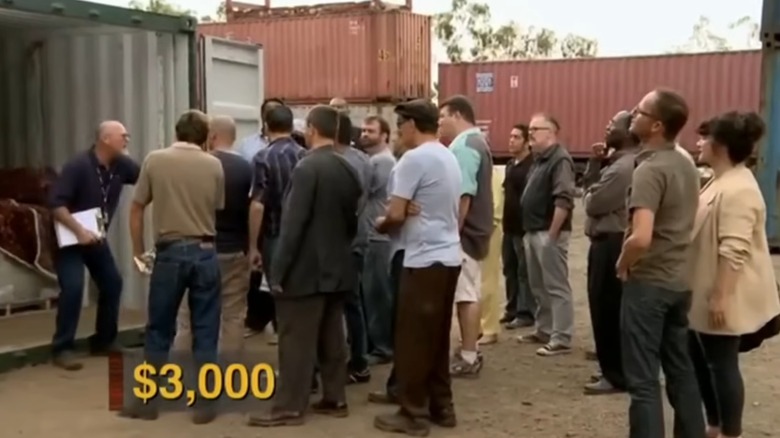 Crowd bidding on shipping container