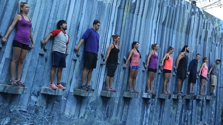 Players standing on a wall in Big Brother (2000)