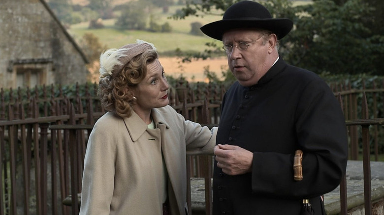 Father Brown helps a lady in "Father Brown" (2013-present)