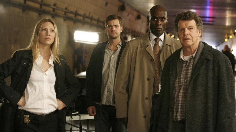 Olivia Dunham, Peter Bishop, Phillip Broyles, and Walter Bishop at a crime scene on "Fringe" (2008-2013)