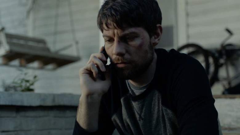 Kyle Barnes sits on the phone on "Outcast" (2016-2018)