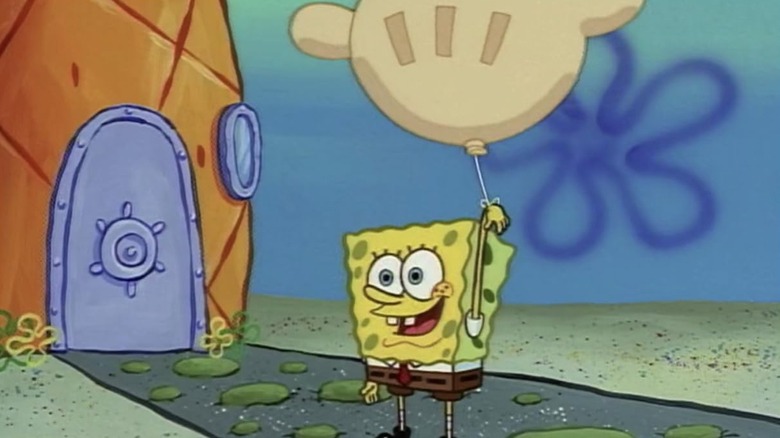 SpongeBob on his way into his pineapple house while holding a large glove-shaped balloon with a smile on his face on SpongeBob SquarePants