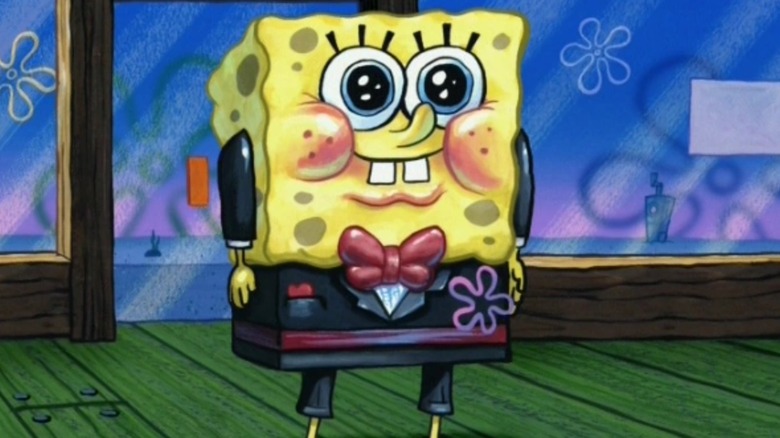 SpongeBob looking adorable and blushing in a pretty black tuxedo with a flower and red bowtie on SpongeBob SquarePants