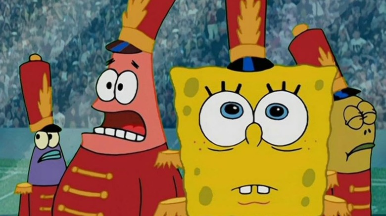 SpongeBob and Patrick dressed in marching band uniforms surrounded by two other fish band members all looking shocked on SpongeBob