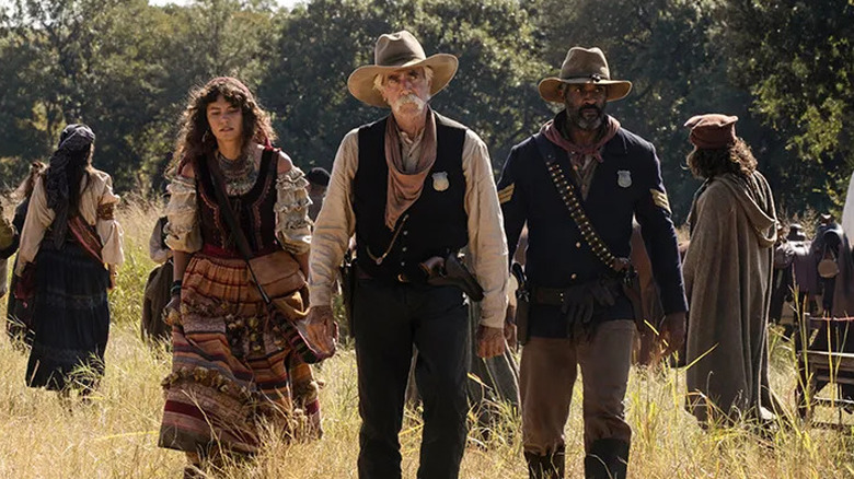 Brennan, Noemi and Thomas walk through the camp in "1883" (2022)