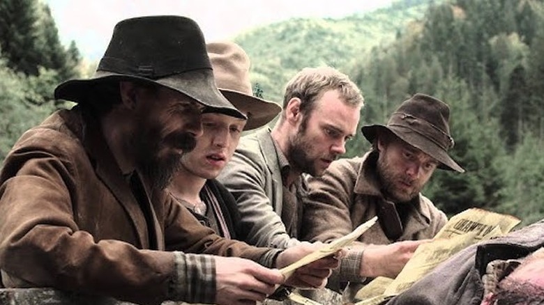 Hatfield and his men look at a dead body in "Hatfields and McCoys" (2012)