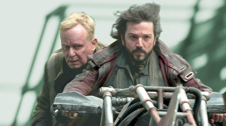 Luthan Rael riding behind Cassian Andor as he drives a motorcycle-like vehicle in "Andor"