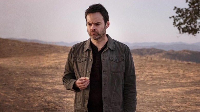 Barry standing in a relatively barren field alone, eating something in "Barry"