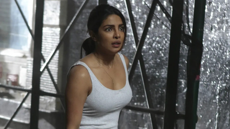 Alex standing in front of shattered windows in "Quantico."