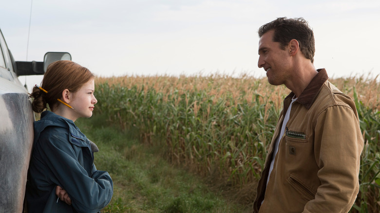 Cooper and his daughter looking at each other