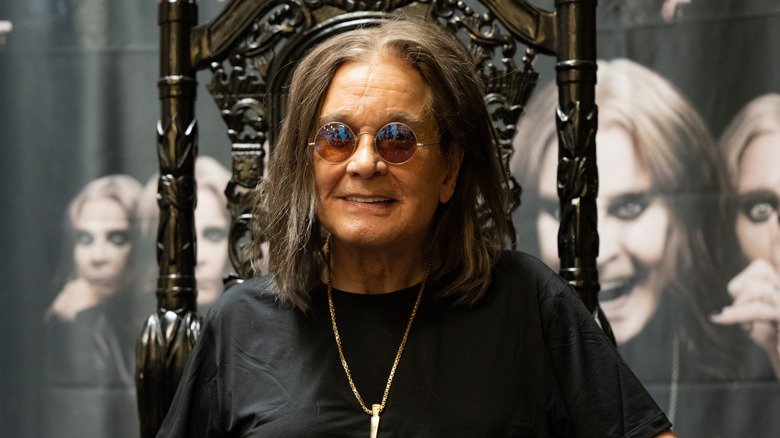 Ozzy Osbourne smiling in gothic chair