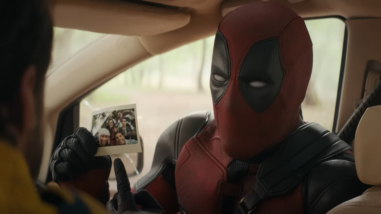 Deadpool points to polaroid