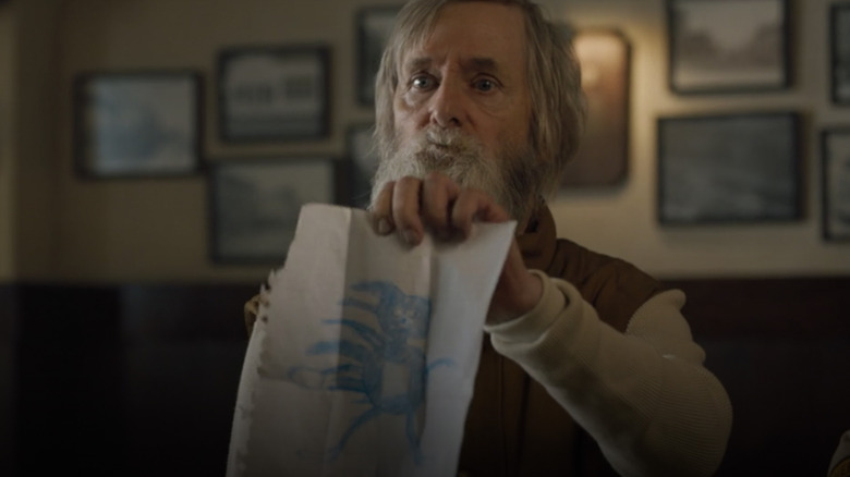 Crazy Carl holding up a drawing