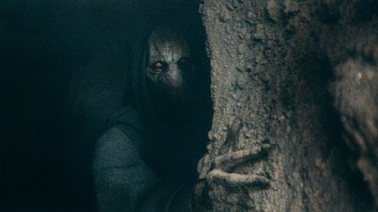 Darth Plagueis looking from behind a cave wall in Star Wars Acolyte