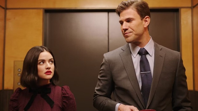 Lucy and Josh staring at each other while standing in an elevator in "The Hating Game."