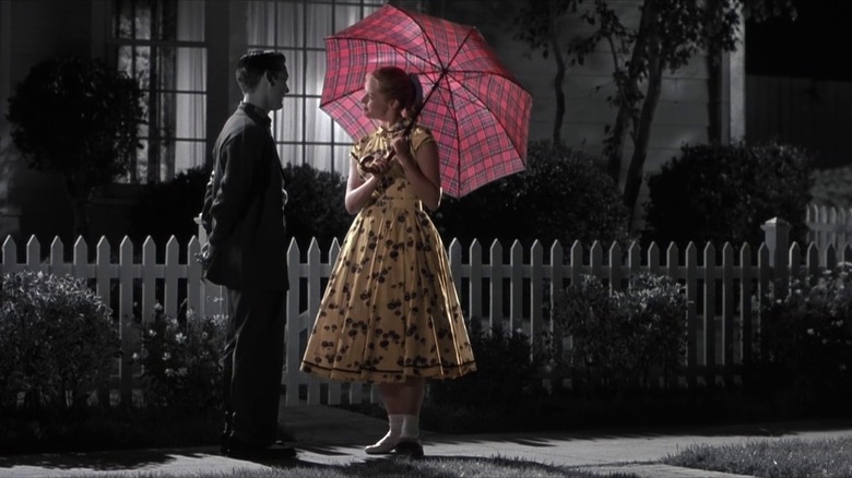 Black and white image with woman and umbrella in color