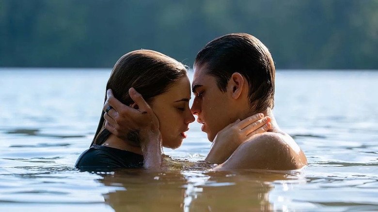 Tessa and Hardin embracing while swimming in a lake in "After"