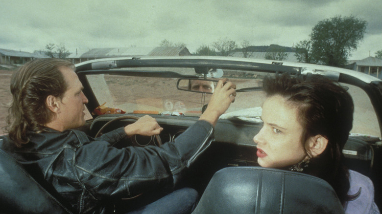 Mickey and Mallory driving in convertible