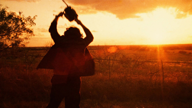 Leatherface silhouetted swinging chainsaw