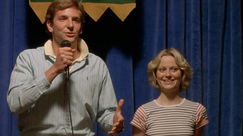 Bradley Cooper and Amy Poehler smile in "Wet Hot American Summer"