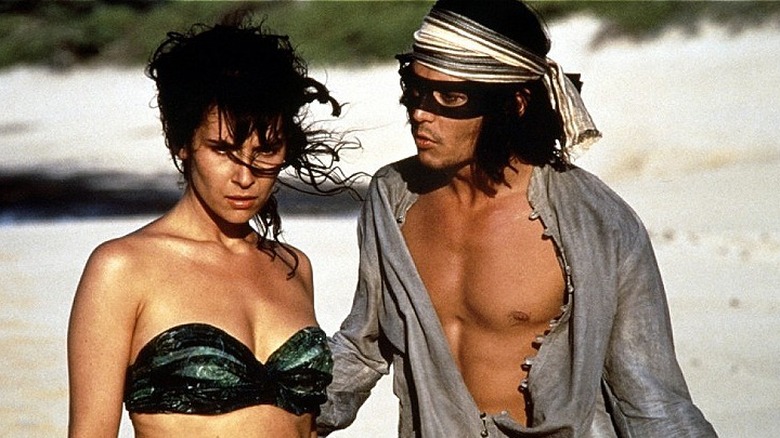 Johnny Depp looks at Geraldine Pailhas on the beach