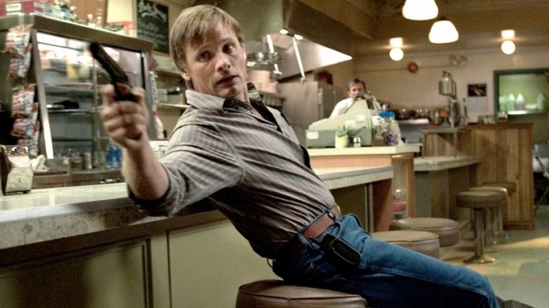 Tom waves a gun around in a diner in A History of Violence (2005)