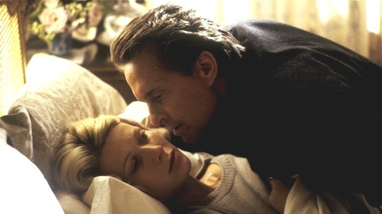 Douglas leaning over Paltrow in bed