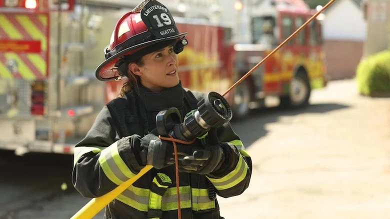 Andy Herrera aiming a fire hose in "Station 19"