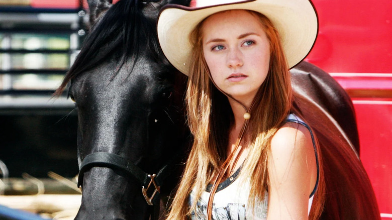 Amy standing with a horse in "Heartland"