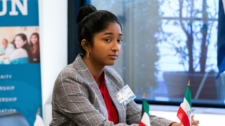 Devi sitting at a model UN table in "Never Have I Ever"