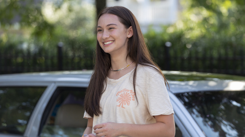 Belly smiling, standing in front of a car in "The Summer I Turned Pretty"