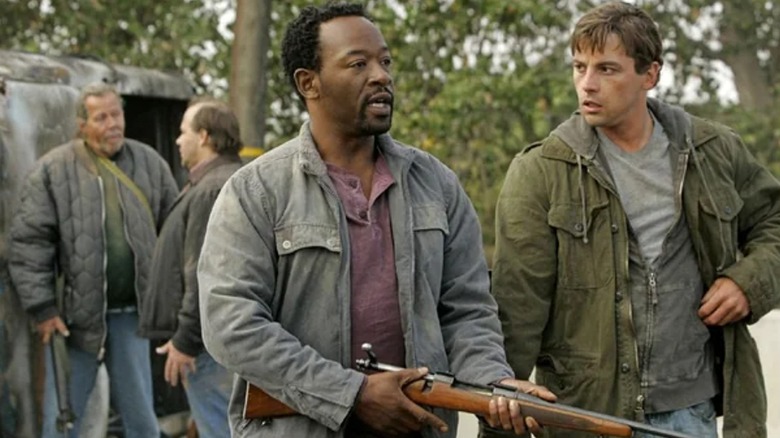 Robert and Jake walking with guns in "Jericho" (2006)