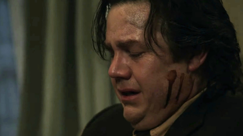 Bloodied Eugene Porter weeping