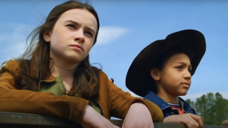 Judith and RJ leaning on fence