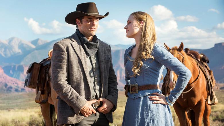 Dolores and Teddy standing with horses