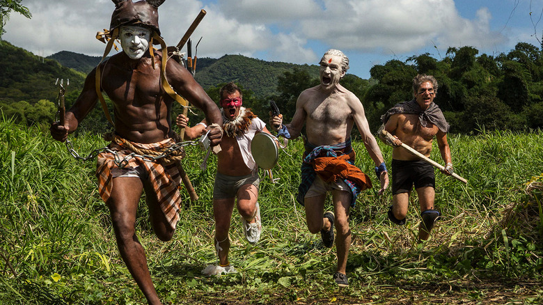 Four men charging forward in the jungle