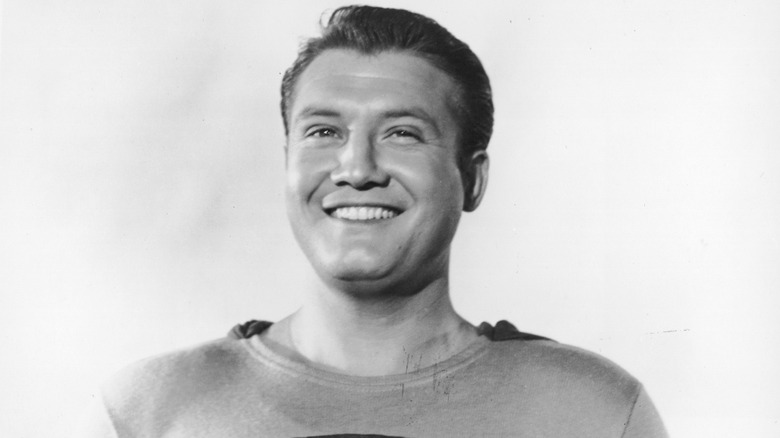 Black-and-white photo of George Reeves posing in a Superman costume in 1953