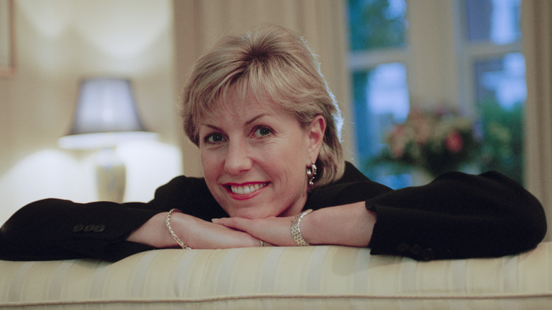 Jill Dando resting her arms on the back of a couch in 1996