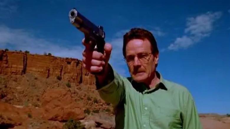 Walter White holds a gun in the desert in "Breaking Bad"