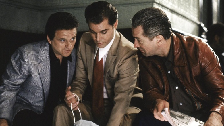 Tommy DeVito, Henry Hill, and Jimmy Conway crouching in "Goodfellas"