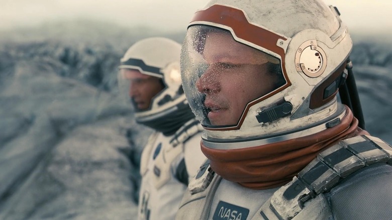 Cooper and Mann gaze out at a planet's surface in "Interstellar" (2014)