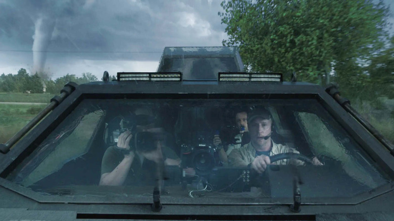 Pete Moore and his storm chasers drive away from a tornado in "Into the Storm" (2014)