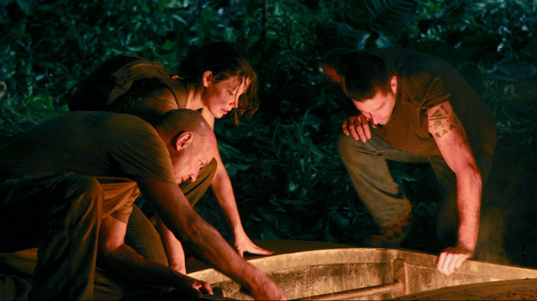 Jack, Locke, and Kate look at the glowing hatch on "Lost" (2004-2010)