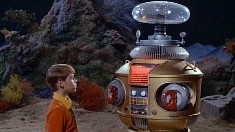 Will Robinson stands next to the Robot on "Lost in Space" (1965-1968)