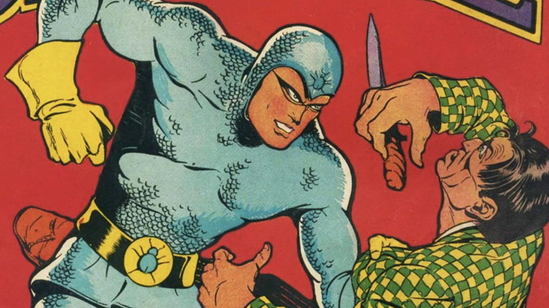 Blue Beetle punches a criminal